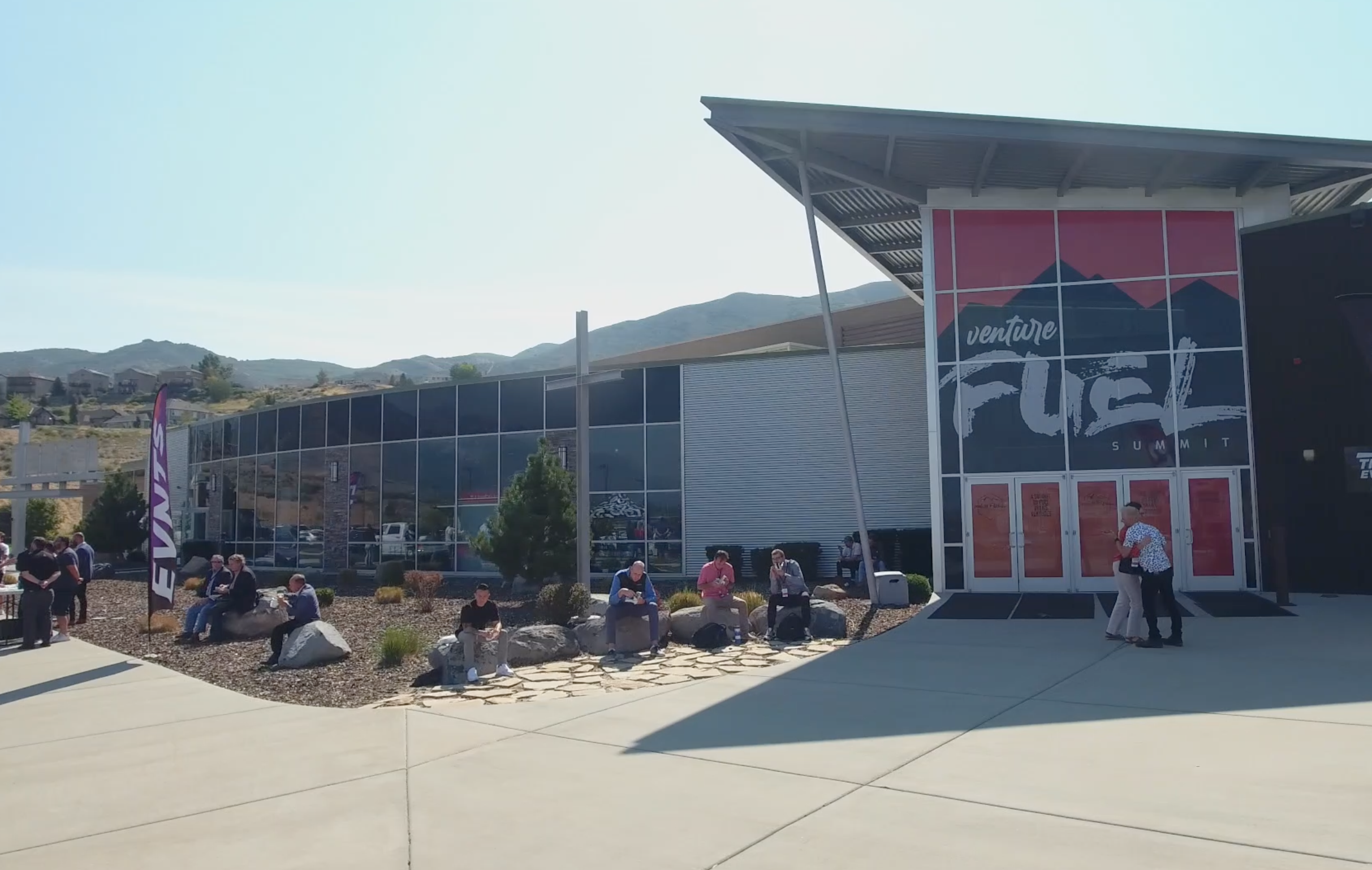 Venture Fuel Summit exterior with branded windows, entrance graphics, and event flags